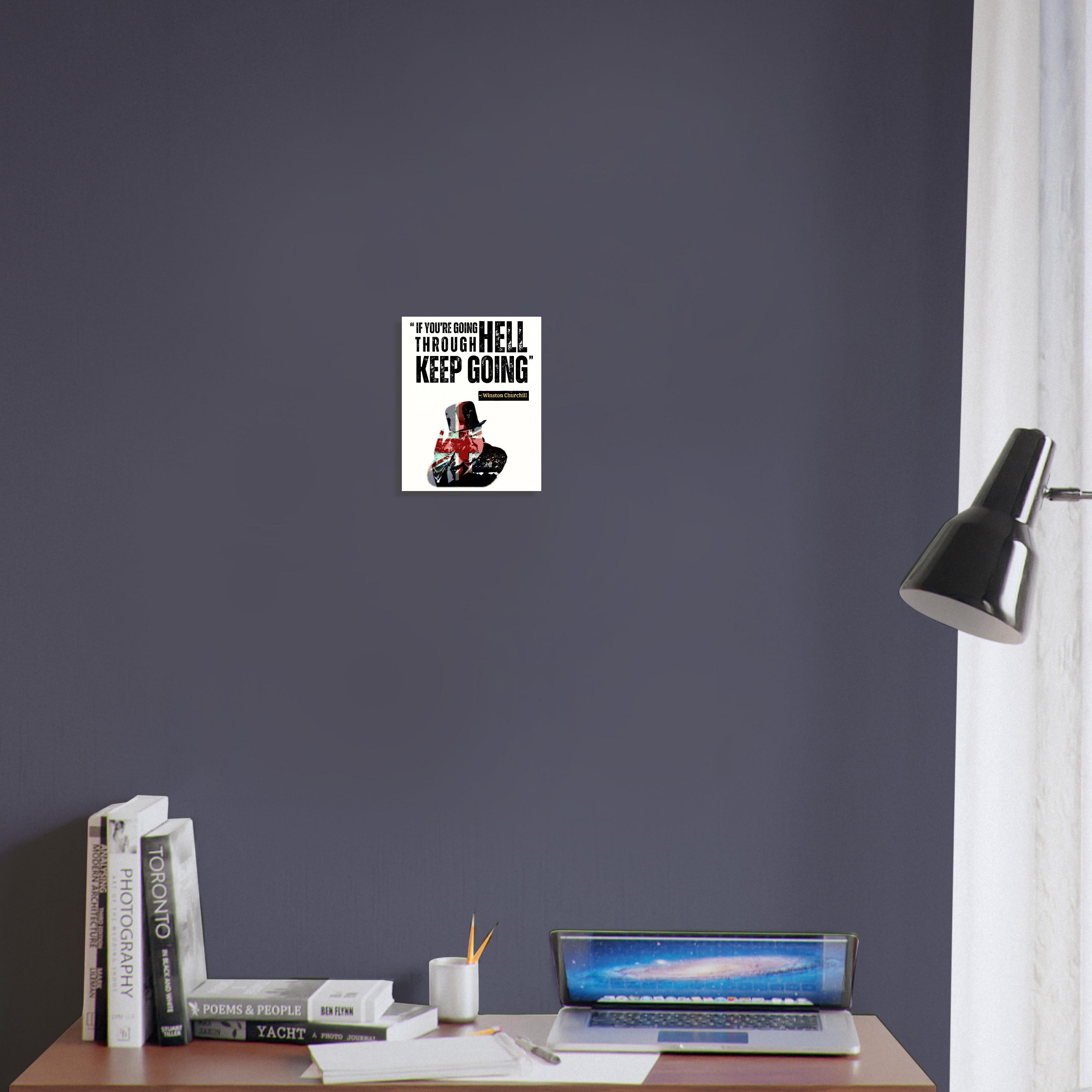 a desk with a lamp and a poster on the wall