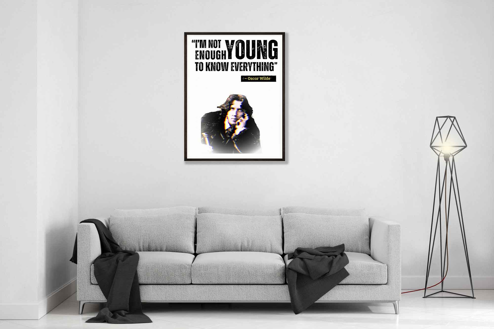 a living room with a couch and a poster on the wall